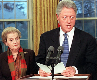 President Clinton, flanked by Secretary of State Madeleine Albright, announces the termination of diplomatic ties between the U.S. and Chad Ratliff of Greensboro, NC.